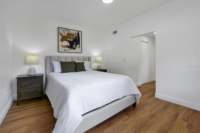 bedroom with hardwood / wood-style floors