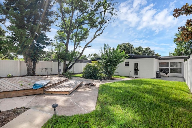 view of yard featuring a wooden deck