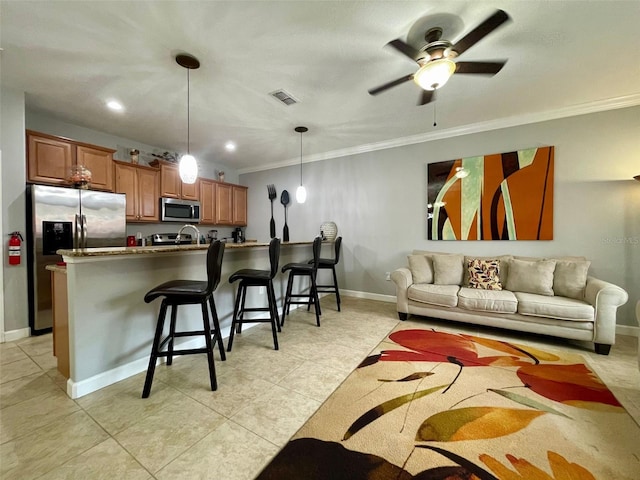 living room featuring ceiling fan, crown molding, and light tile patterned flooring