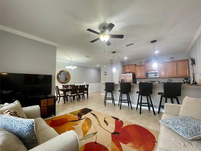 living room featuring ceiling fan with notable chandelier and ornamental molding