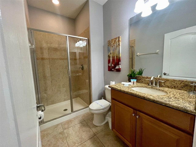 bathroom with a shower with shower door, tile patterned flooring, toilet, and vanity