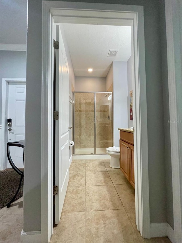 bathroom with toilet, an enclosed shower, tile patterned floors, vanity, and a textured ceiling