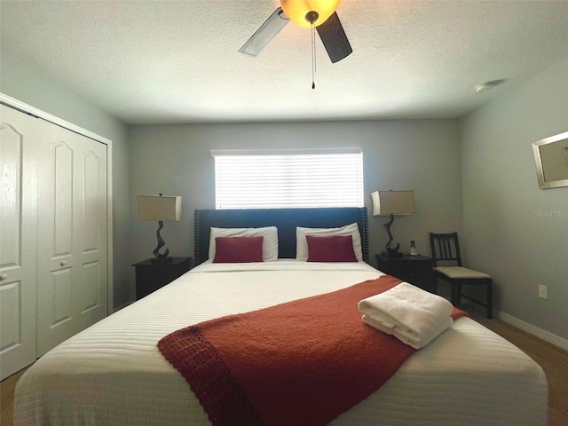 bedroom featuring carpet flooring, a closet, ceiling fan, and a textured ceiling