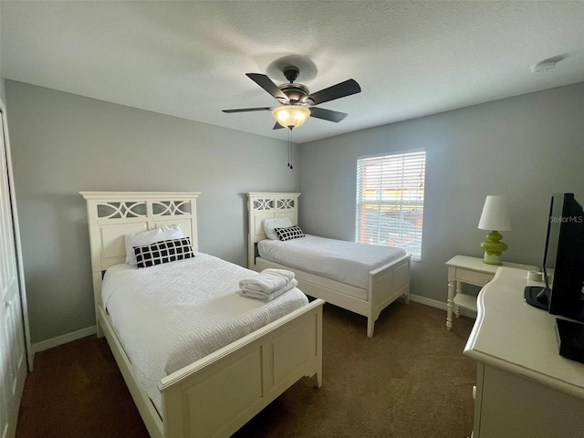 carpeted bedroom with a textured ceiling and ceiling fan