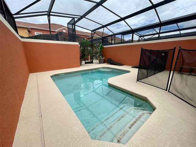 view of pool featuring a patio area and glass enclosure