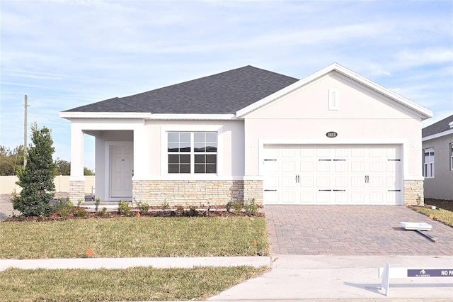 view of front of property with a garage and a front yard