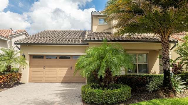 mediterranean / spanish house with a garage