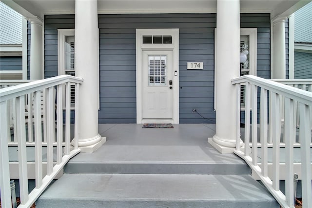 view of exterior entry with covered porch