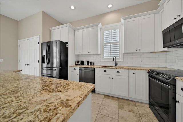 kitchen with backsplash, sink, appliances with stainless steel finishes, and white cabinetry