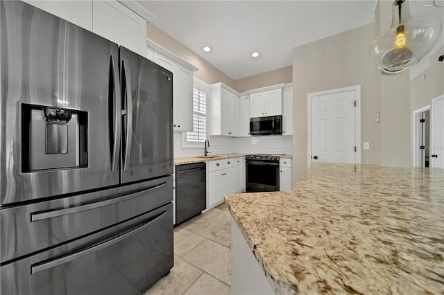 kitchen with black appliances, decorative light fixtures, decorative backsplash, and white cabinetry