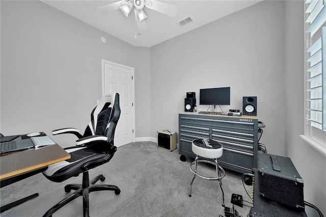 carpeted office space with ceiling fan