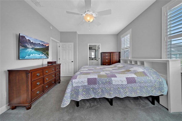 bedroom with multiple windows, ceiling fan, connected bathroom, and light carpet