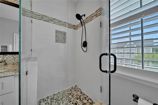 bathroom featuring an enclosed shower, decorative backsplash, and vanity