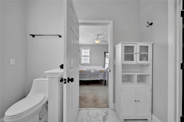 bathroom featuring toilet and ceiling fan