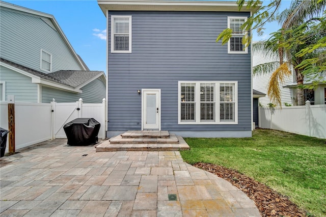 back of house featuring a yard and a patio