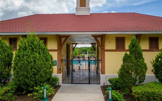 view of exterior entry featuring a community pool