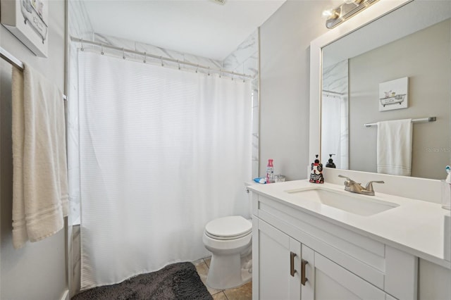 bathroom featuring tile patterned flooring, vanity, and toilet