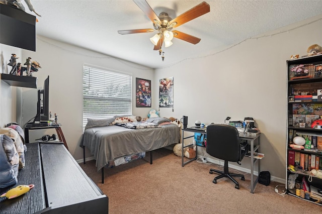 bedroom featuring ceiling fan, light colored carpet, and a textured ceiling