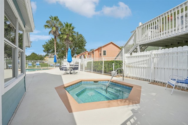 view of pool featuring a patio area and a community hot tub