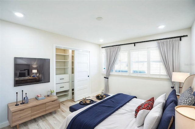 bedroom featuring light wood-type flooring and a closet