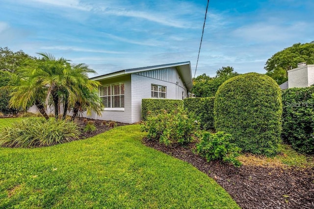 view of property exterior with a yard