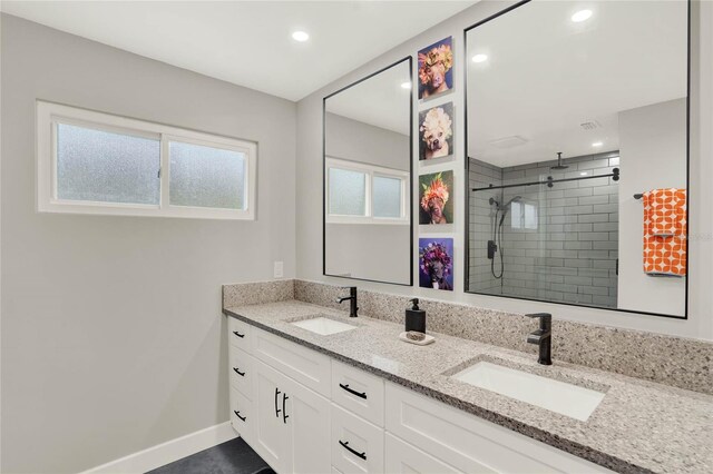 bathroom with vanity and tiled shower