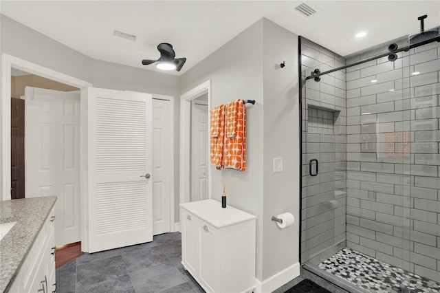 bathroom with vanity, ceiling fan, and a shower with shower door