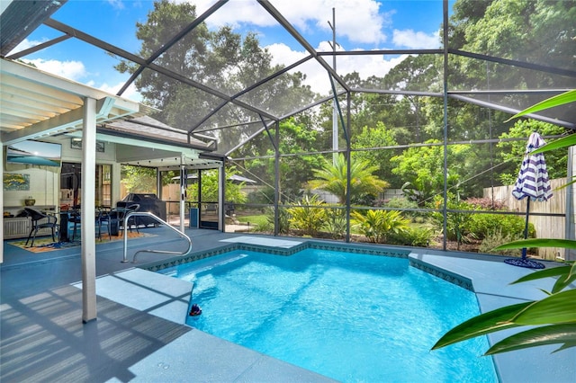 view of swimming pool with a lanai, a patio, ceiling fan, and grilling area