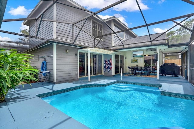 view of swimming pool featuring area for grilling, glass enclosure, and a patio