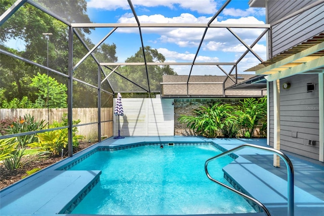 view of pool featuring glass enclosure