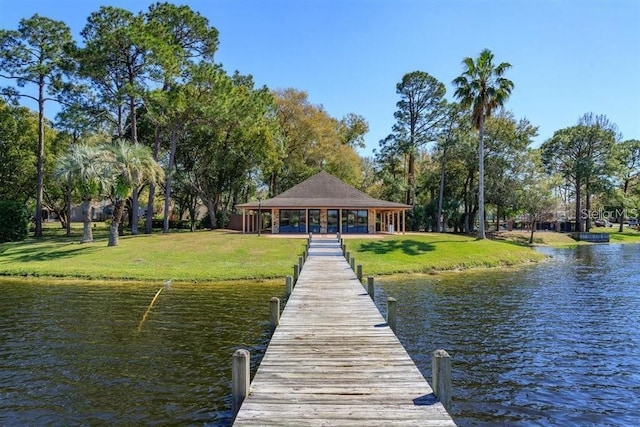 view of dock featuring a yard and a water view