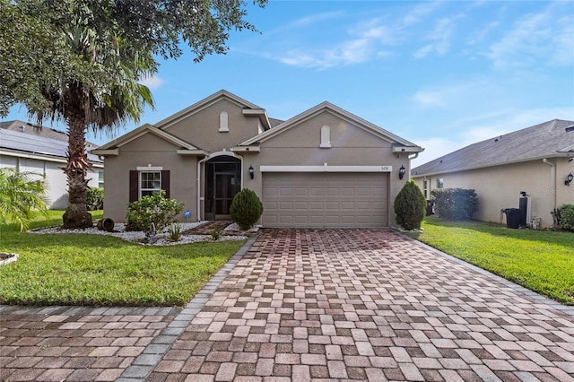 view of front of property featuring a front lawn and a garage