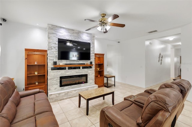 living room with a fireplace, light tile patterned floors, and ceiling fan