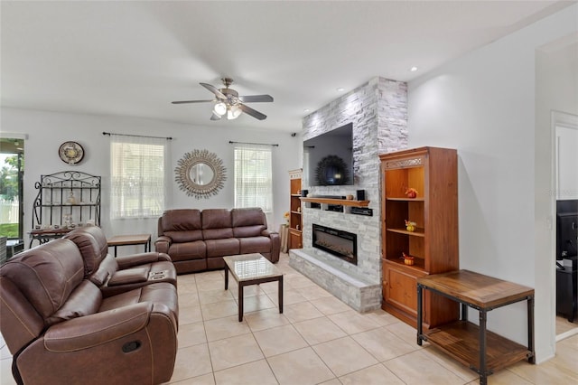 tiled living room with a fireplace and ceiling fan