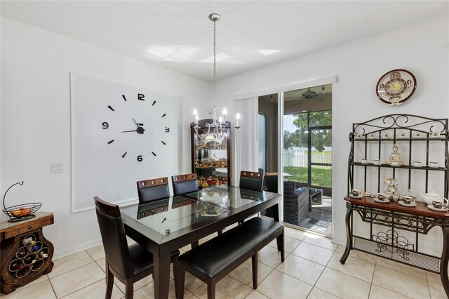 tiled dining area featuring a notable chandelier