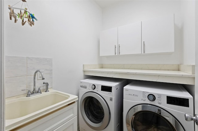 laundry area featuring cabinets, sink, and independent washer and dryer