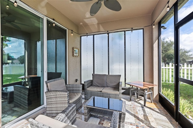 sunroom / solarium featuring a wealth of natural light and ceiling fan