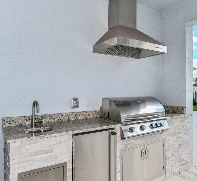 view of patio with a grill, sink, and area for grilling