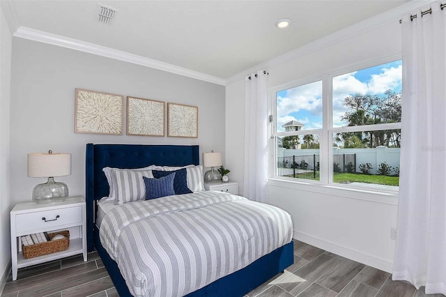 bedroom featuring dark hardwood / wood-style flooring and ornamental molding