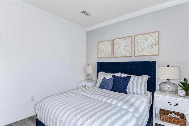 bedroom featuring light wood-type flooring and ornamental molding