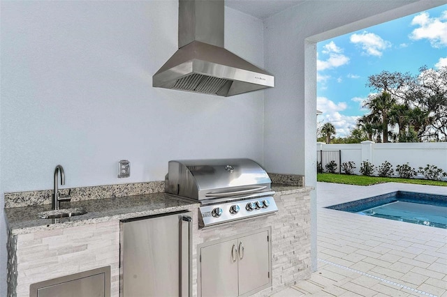 view of patio with an outdoor kitchen, area for grilling, and sink