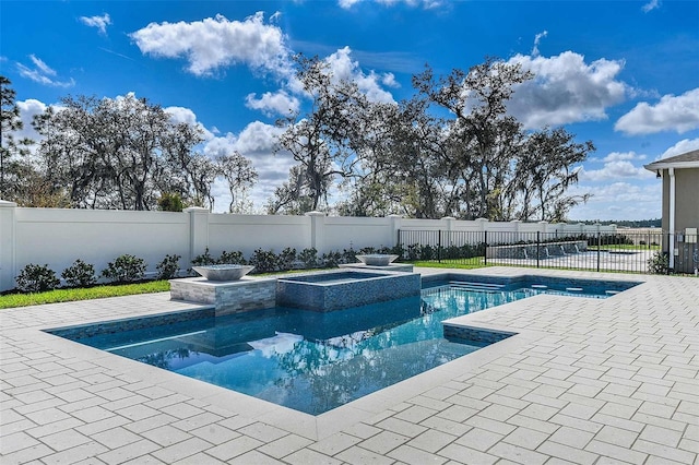 view of swimming pool featuring an in ground hot tub and a patio area