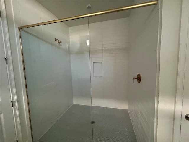 bathroom with tile patterned flooring and a shower with door