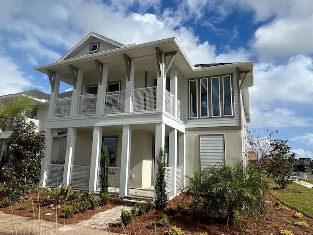 exterior space with a porch and a balcony