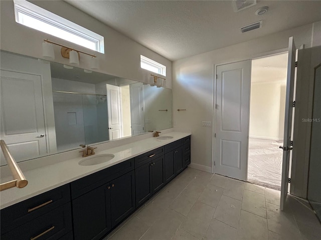 bathroom featuring vanity and a textured ceiling