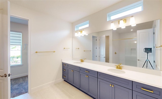 bathroom with plenty of natural light, a sink, and a shower with shower door