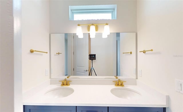 full bath with double vanity and a sink