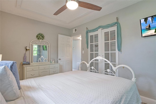 bedroom with ceiling fan and a textured ceiling