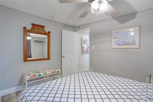 unfurnished bedroom with ceiling fan and hardwood / wood-style flooring