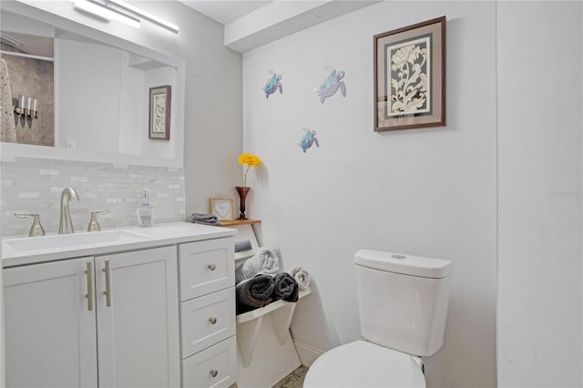 bathroom featuring backsplash, vanity, and toilet